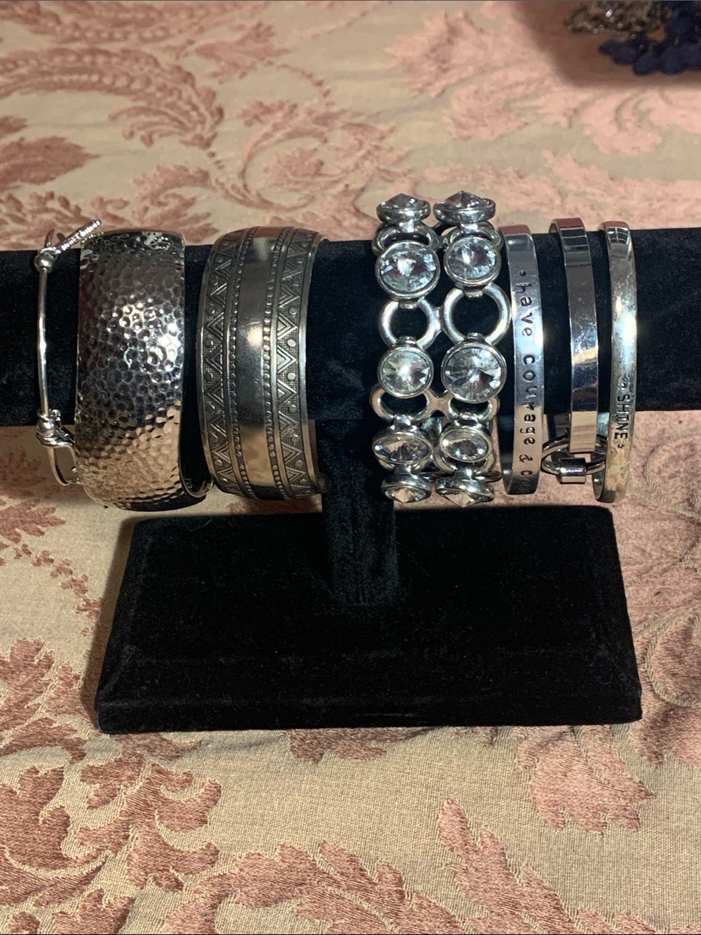 A collection of silver tone bracelets